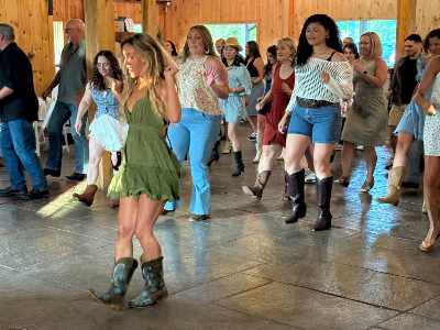 Group of people dancing in a wooden hall